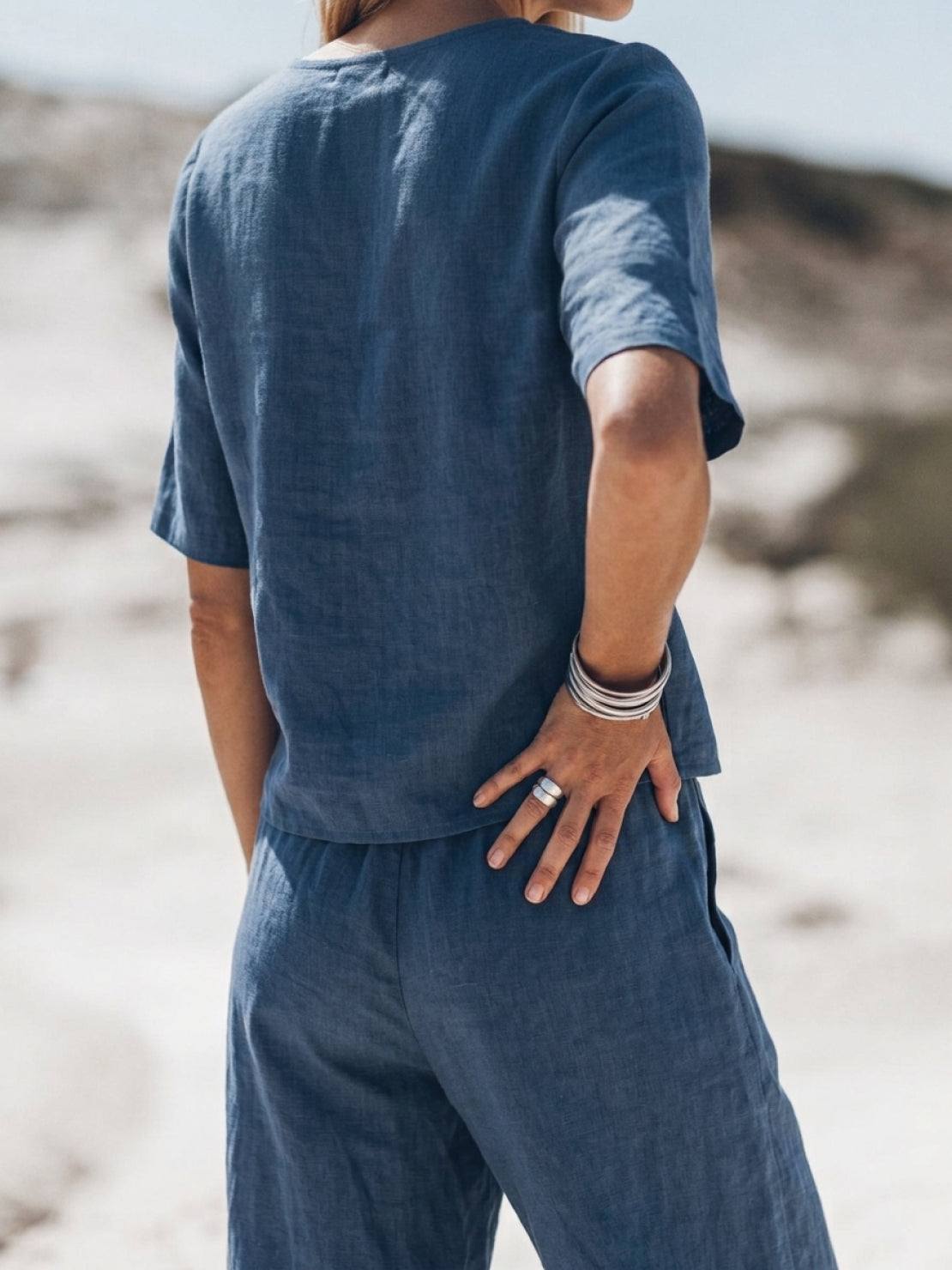 Woman wearing soft-tailored loose fit co-ord set with wide-leg cotton trousers in light fabric