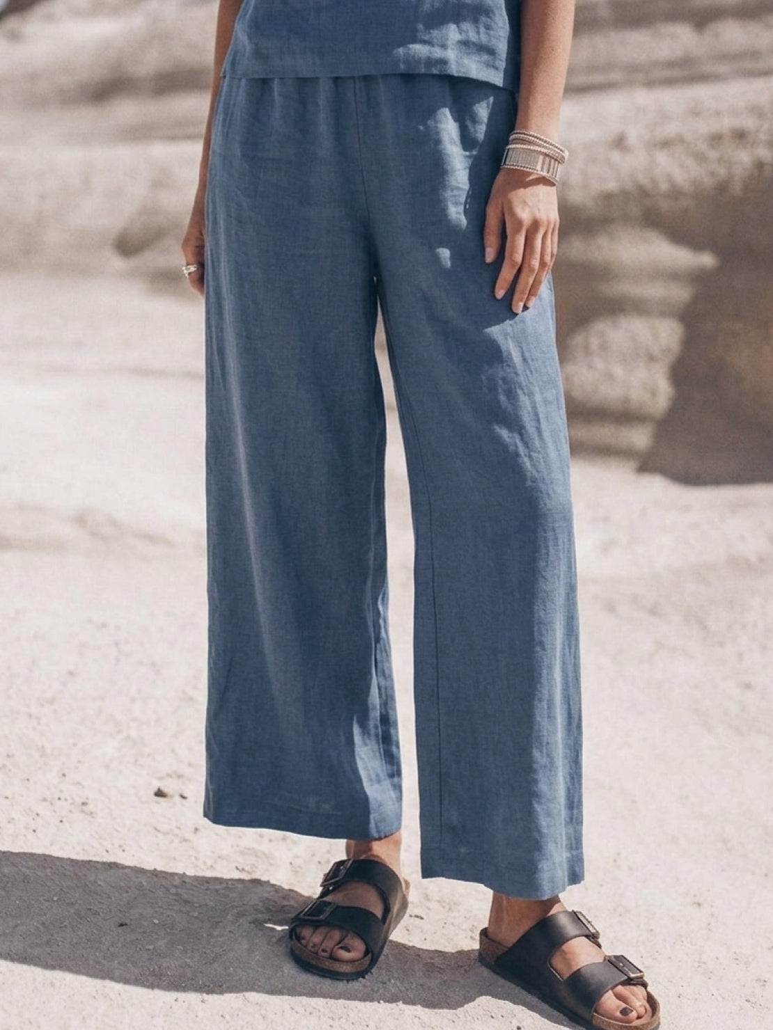 Woman wearing a soft cotton loose fit co-ord set with a tailored top and wide-leg pants in a relaxed fit