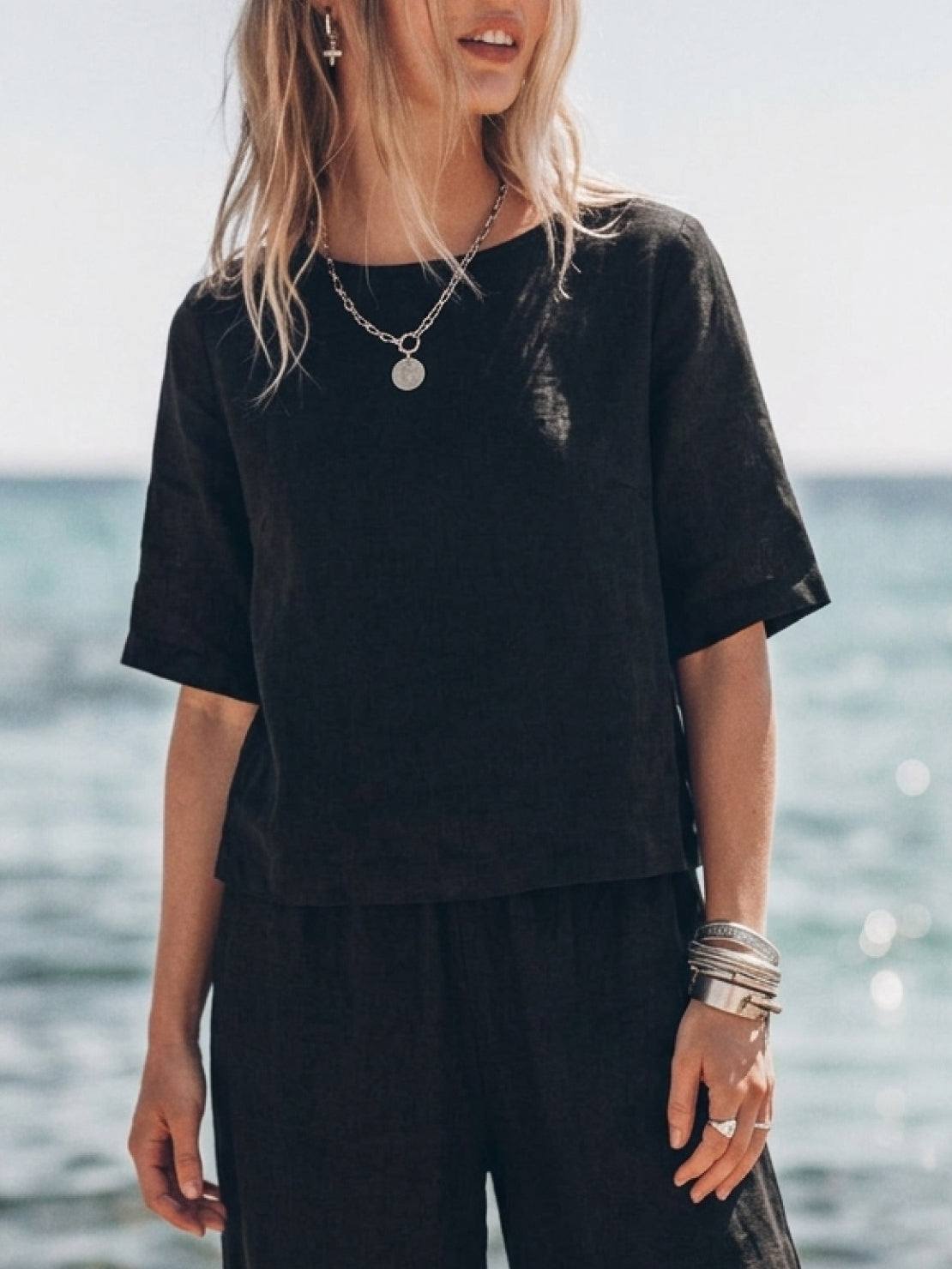 Woman wearing a soft cotton loose fit co-ord set with wide-leg trousers and a relaxed short-sleeve top