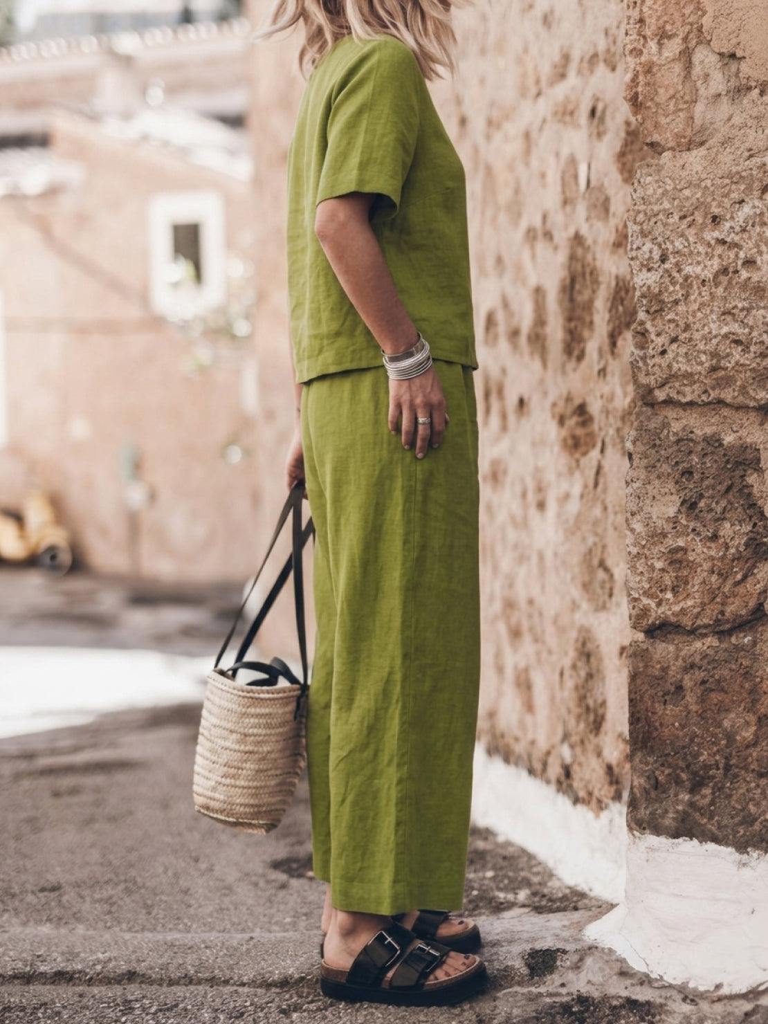 Woman wearing beige loose fit co-ord set with short sleeves and wide-leg pants standing outdoors