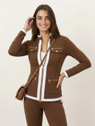woman wearing sleek contrast zip two-piece outfit standing against white background