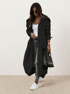 sleek minimalist oversized hooded coat in black on hanger for travel and layering