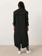 woman wearing sleek minimalist hooded coat outdoors