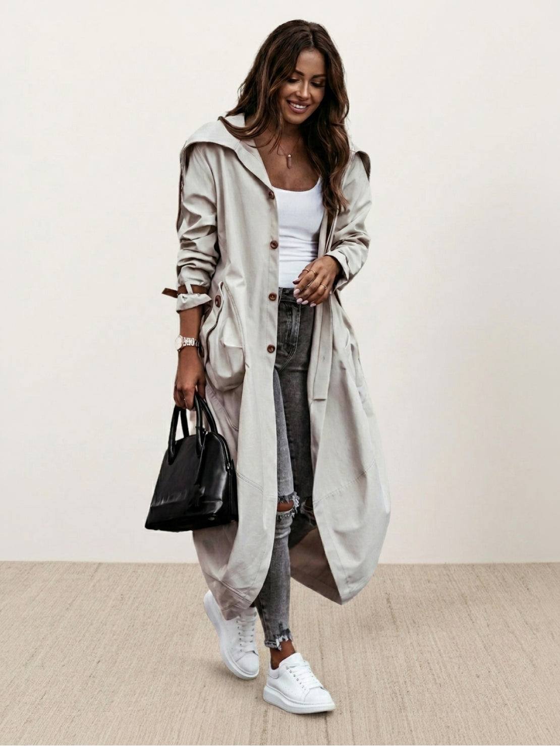 Minimalist hooded coat with oversized fit and sleek design for travel and layering