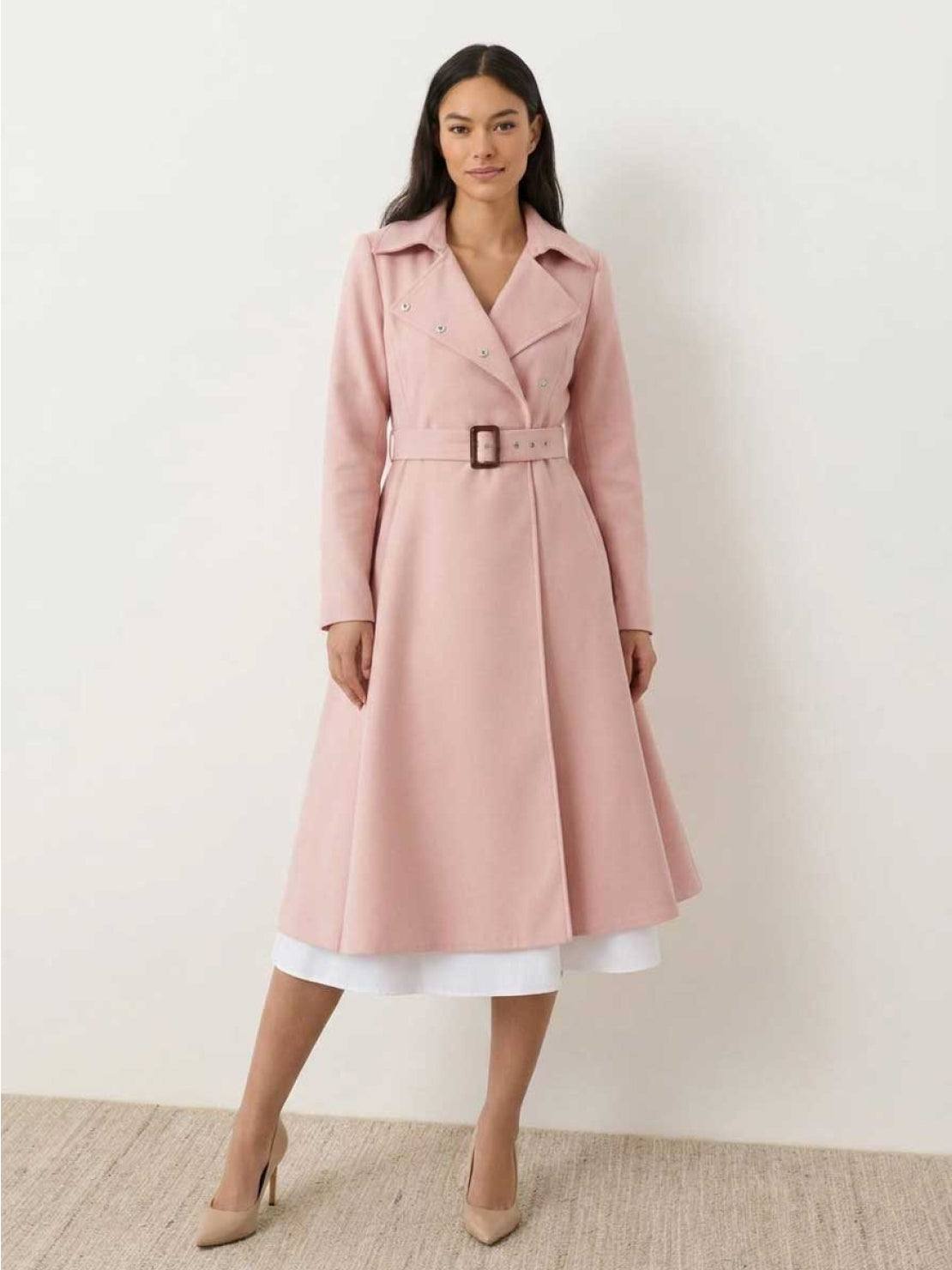 Woman wearing water-repellent A-line hooded raincoat with belt in light pink