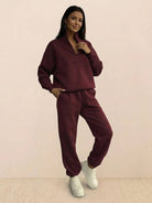 woman wearing cotton-blended two-piece tracksuit with high collar and deep zipper in casual athleisure style