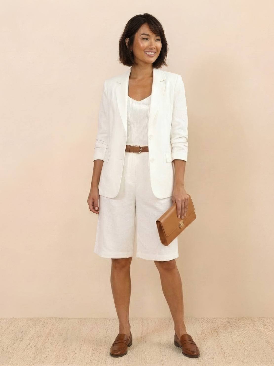 Woman wearing a stylish blazer and high-waisted shorts two-piece set in a polished, tailored look
