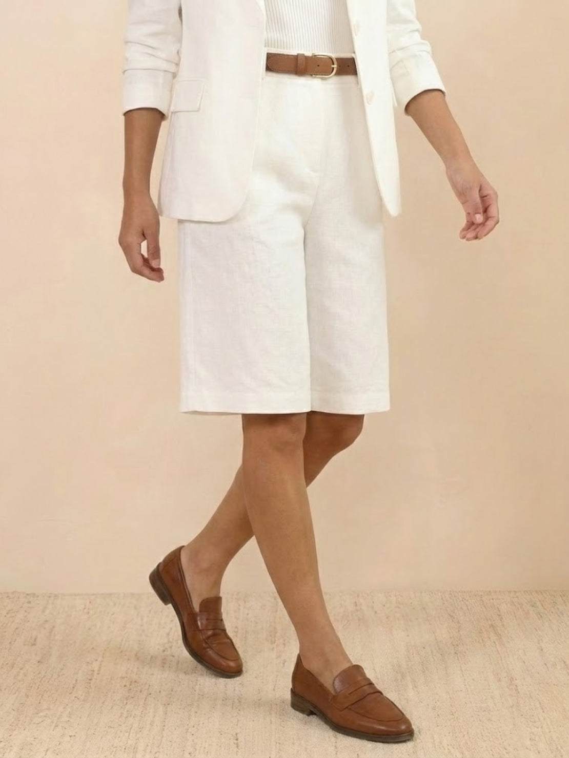 Woman wearing a polished blazer and high-waisted shorts two-piece set in a monochrome outfit