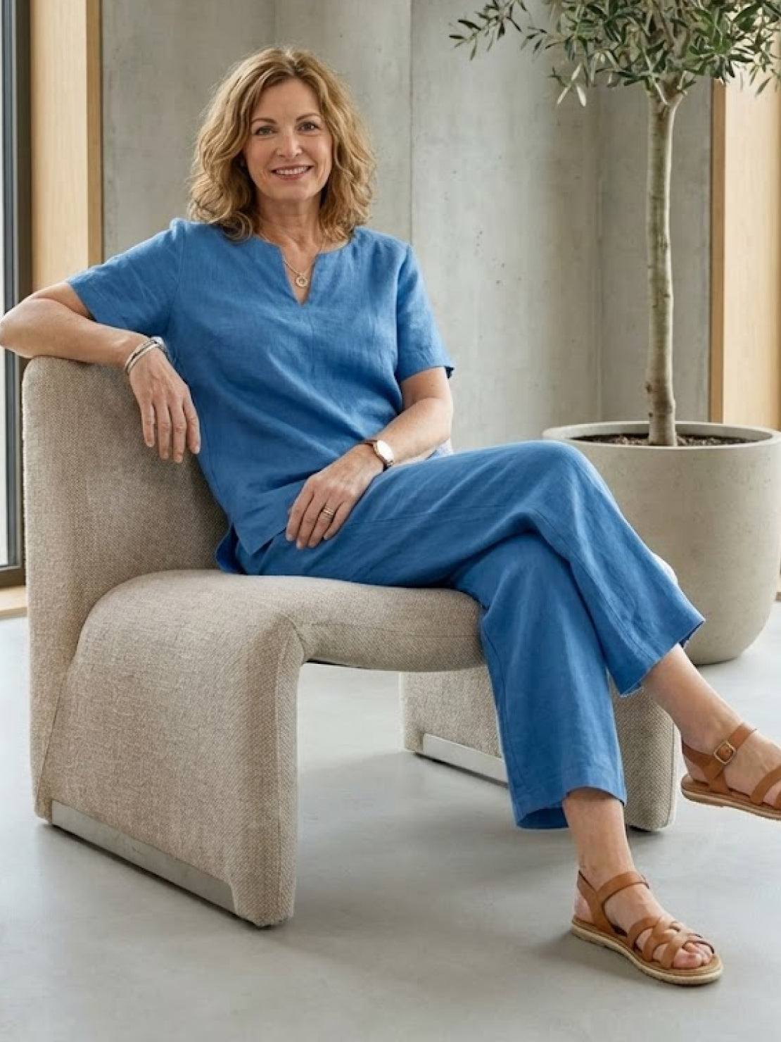 Woman wearing breezy cotton blend two-piece set with short-sleeved shirt and elastic waist pants