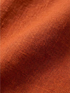 Woman wearing capped-sleeve voluminous pleated midi dress with pockets and flowing skirt