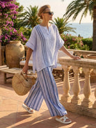 Coastal Comfort Linen two-piece set with artisan crochet details and flowing wide-leg pants on white background