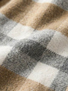 Close-up of comfy flannel classic checkered fabric in beige, gray, and white colors