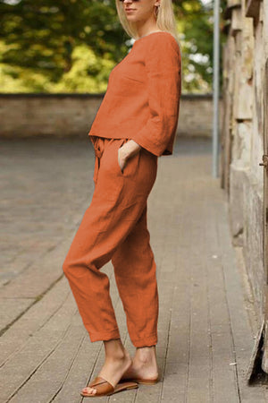 woman wearing relaxed cotton-linen monochrome capsule outfit in rust color outdoors