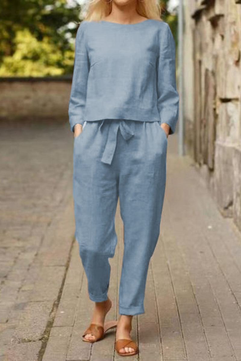 Woman wearing blue cotton-linen monochrome relaxed longline top and wide-leg pants outdoors