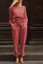 Woman wearing relaxed cotton-linen monochrome capsule set with longline top and wide-leg pants in muted rose color