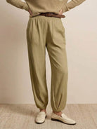 European minimalism relaxed sweater top and khaki trouser set with belt and white loafers