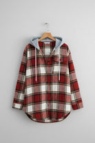 Highland Plaid Shacket with soft fleece lining, attached hood, button-front, and front pockets in red and white plaid pattern.