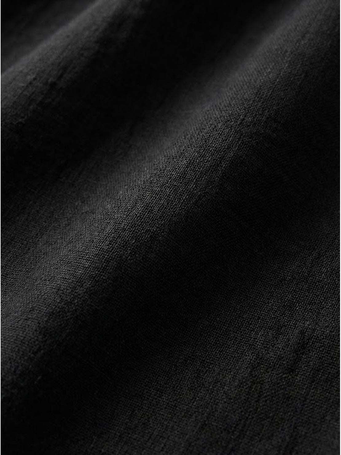 Close-up of black loose solid color fabric texture for breathable two-piece set