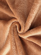 Close-up of soft plush faux fur fabric in light brown for open front oversized fur jacket