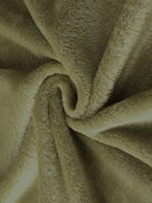 Close-up of soft plush faux fur fabric in light olive green for open front oversized fur jacket