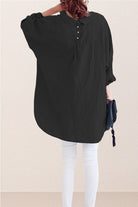 Oversized black linen shirt with back button details and relaxed fit on model