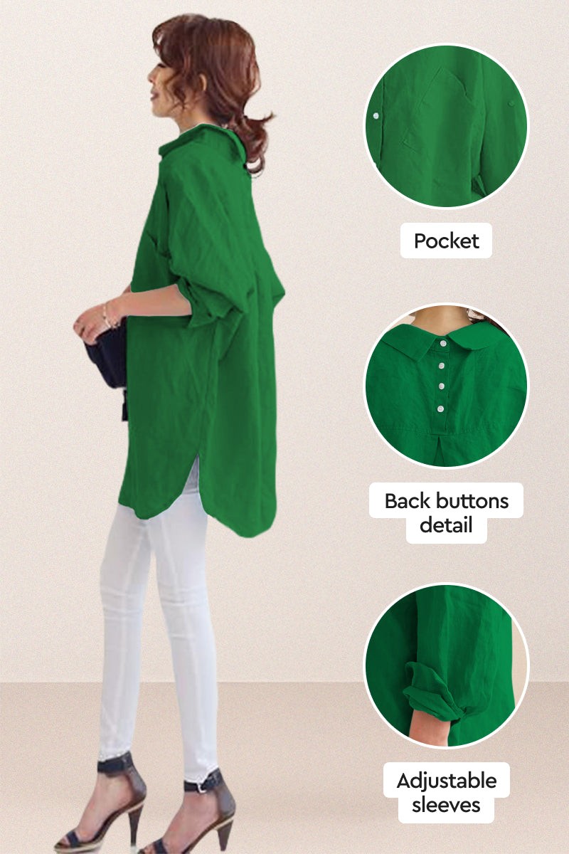 Green oversized linen shirt with back button detail, pocket, and adjustable sleeves worn with white pants
