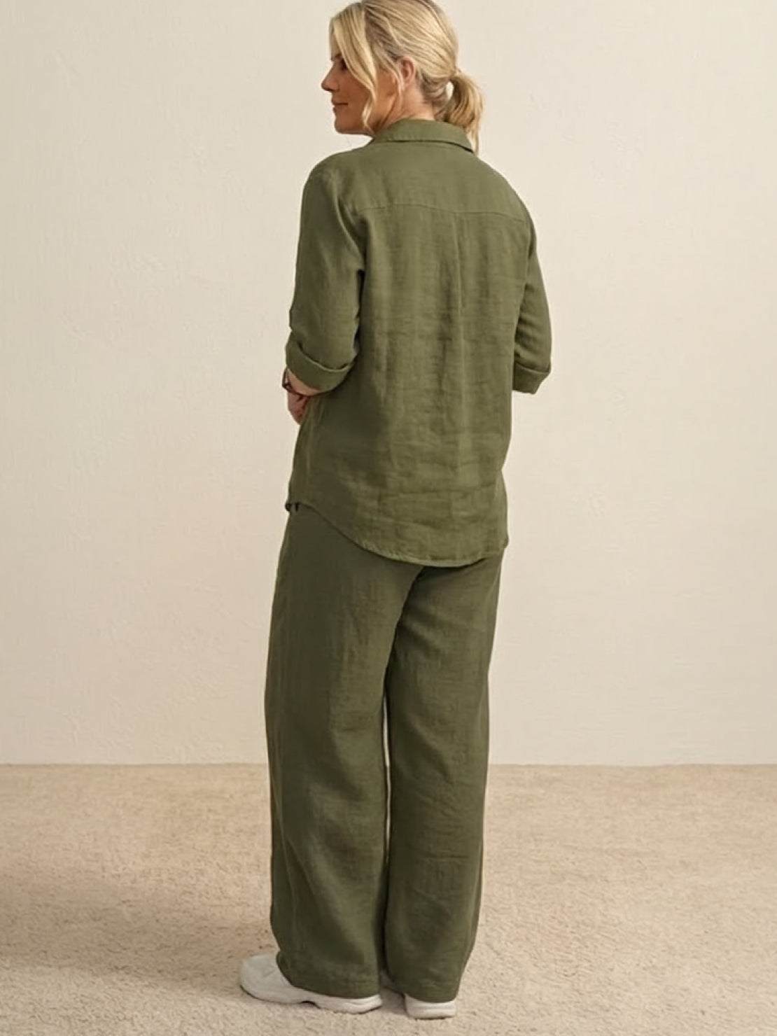Back view of model wearing oversized 100% cotton olive green shirt and wide-leg pants co-ord set