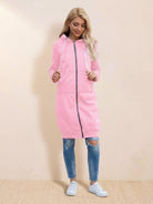 Woman wearing pink oversized long zip sweatshirt hoodie with drawstring hood and front pockets