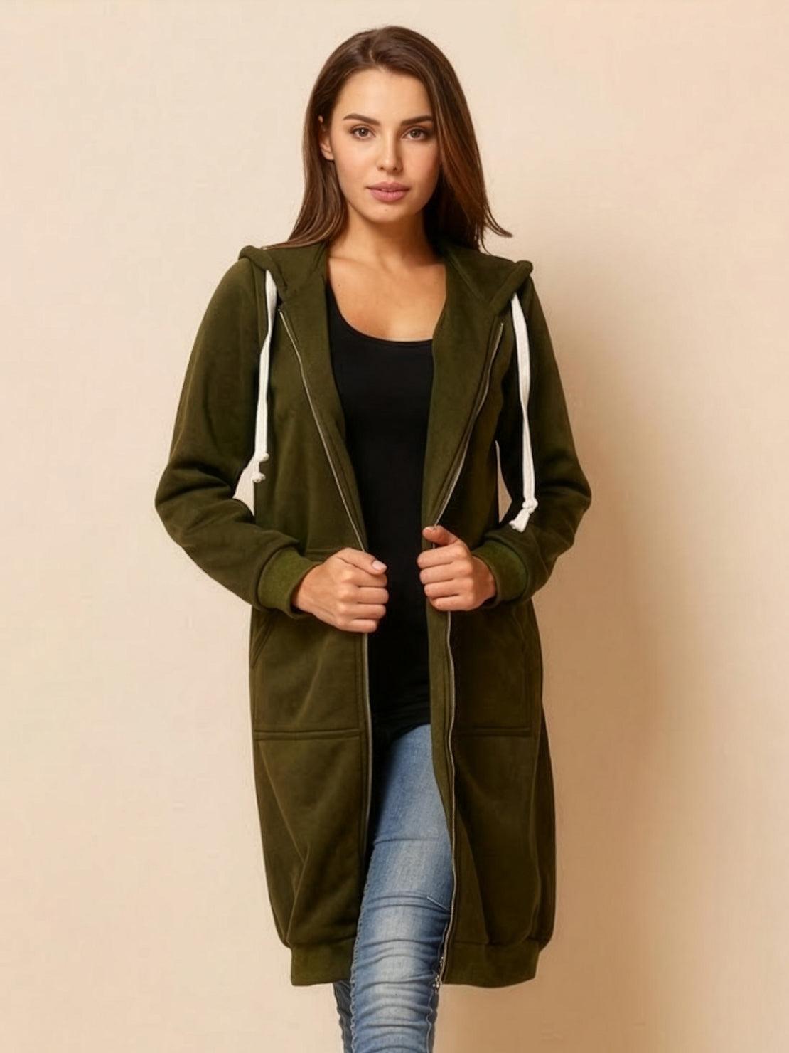 Woman wearing oversized long zip sweatshirt hoodie in olive green with front pockets and hood
