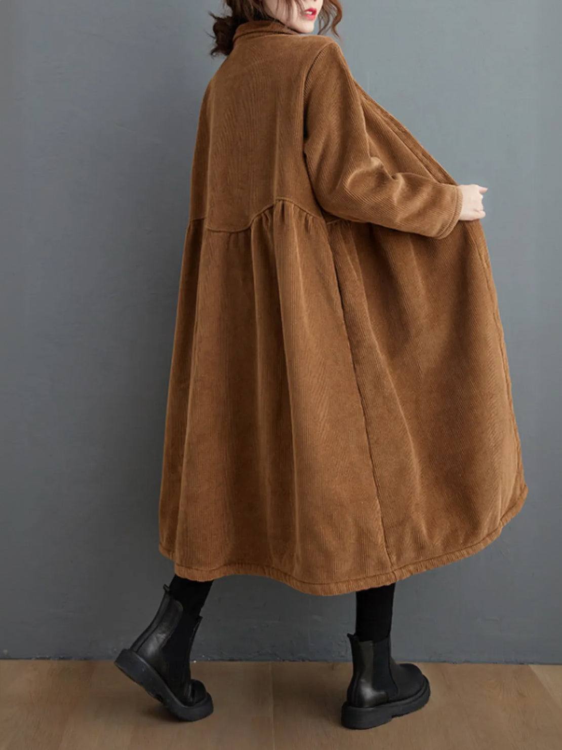 Woman wearing an oversized vintage corduroy coat in warm earth tones