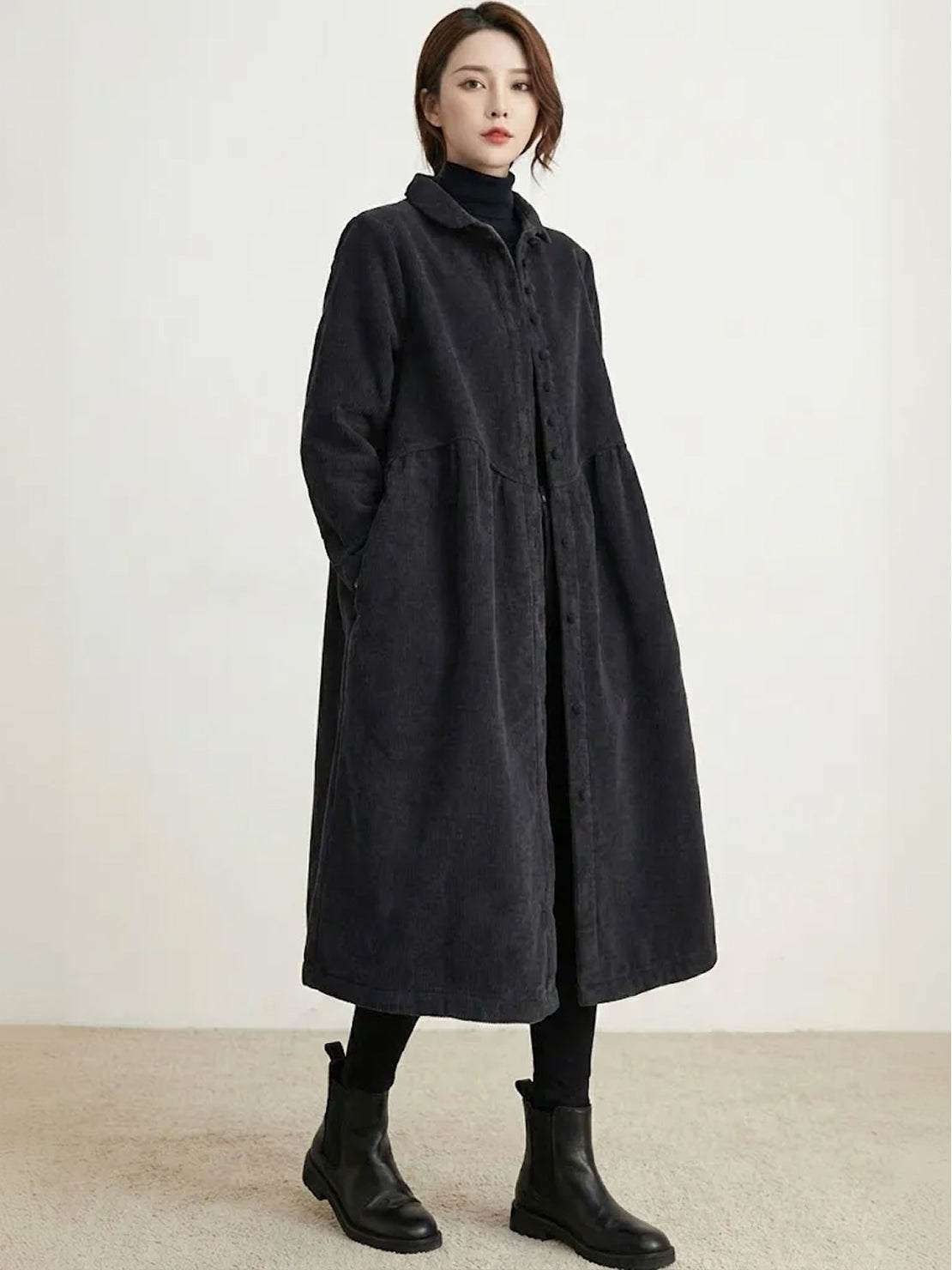 Woman wearing oversized vintage corduroy coat in warm earth tones with cozy texture and roomy fit