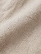 Close-up of soft beige pure linen fabric texture for age-defying shirt