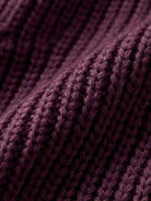 Close-up of soft, ribbed knit fabric in deep purple for relaxed fit oversized cardigan
