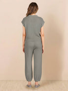 Woman wearing Comfy Couture knit sweater two-piece set in neutral color, relaxed fit with matching pants