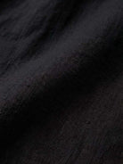 Close-up of black relaxed loose breathable linen fabric texture