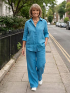 Woman wearing oversized 100% cotton shirt and wide-leg pants co-ord set in breathable fabric
