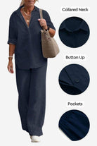 Woman wearing navy relaxed shirt and trousers two-piece set with collared neck, button-up front, and pockets, styled casually with a handbag.