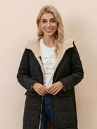 Woman wearing black Sherpa-lined hooded teddy coat with cozy sherpa interior and front pockets