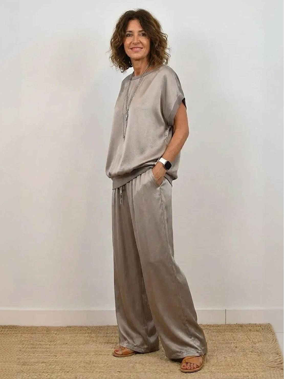woman wearing Silken Escape satin two-piece set with flowing wide-leg pants and slim-fit top