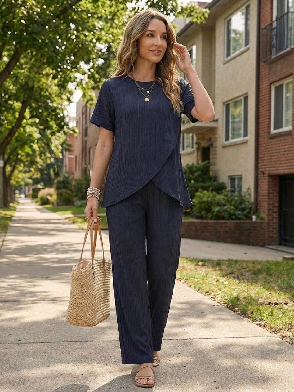 Woman wearing Textured Elegance two-piece set with asymmetrical top and wide-leg pants