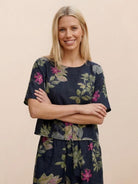 woman wearing floral print loose fit co-ord set with short sleeves and wide-leg trousers