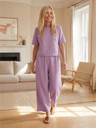 Woman wearing loose fit co-ord set with soft-tailored top and wide-leg bottoms in a relaxed summer style