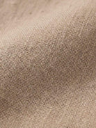 Close-up of beige lightweight cotton fabric texture for cotton dress