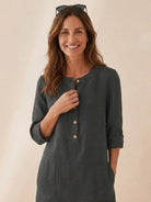 woman wearing dark grey 3/4 sleeve cotton dress with button front and pockets