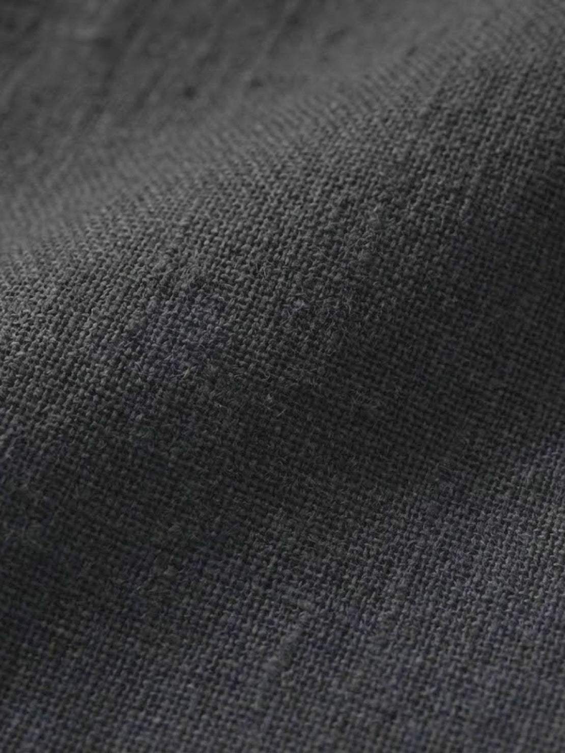 Close-up texture of dark gray cotton fabric for breathable cotton dress material