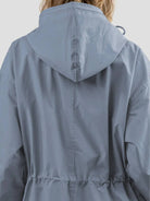 Water-resistant oversized hooded windbreaker rain jacket with multiple pockets and adjustable waist for outdoor activities